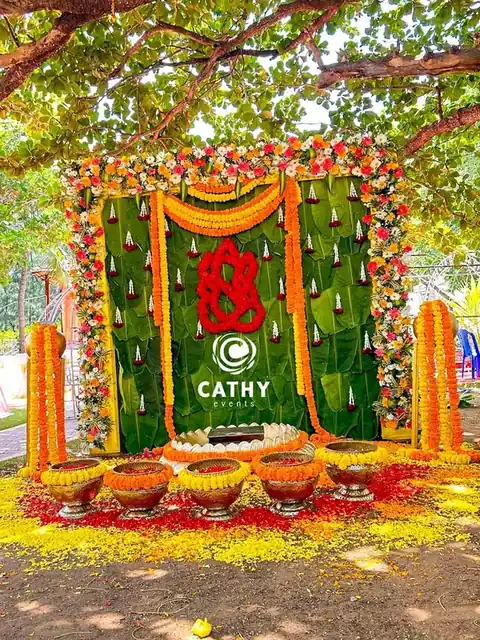 Ganesha backdrop with marigolds and brass lamps
